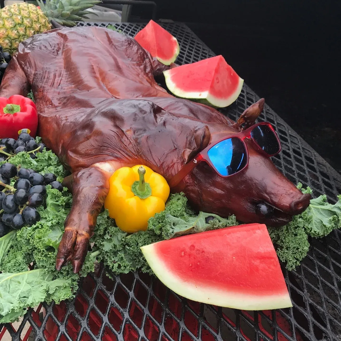 Whole smoked pig with sunglasses