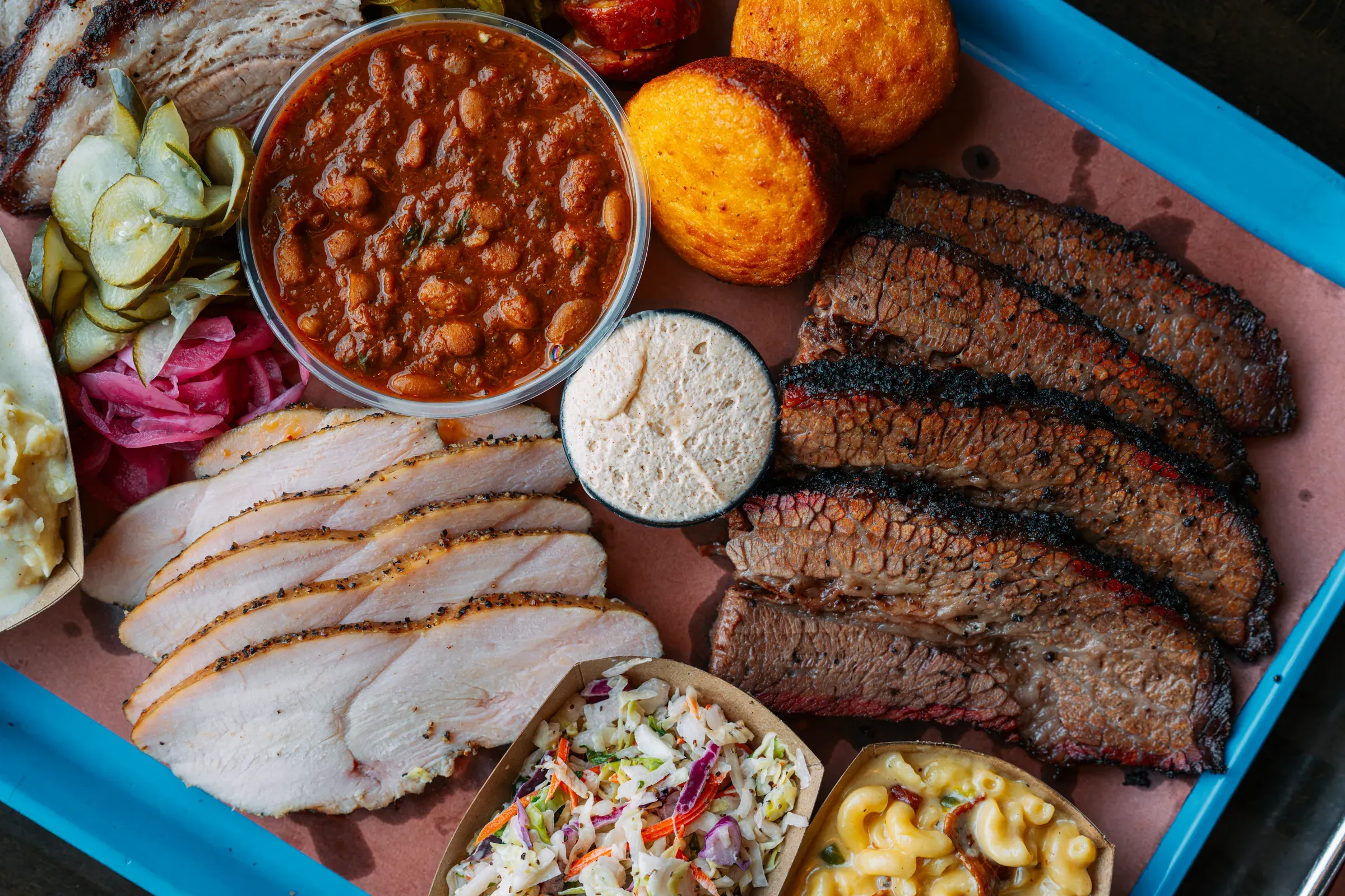 Post Oak brisket, turkey and sides on a tray